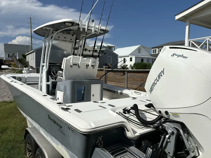  Yacht Photos Pics 2019 Tidewater 2700 Carolina Bay boat with Mercury engine, parked on a trailer.