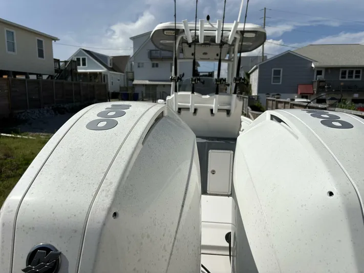  Yacht Photos Pics 2019 Tidewater 2700 Carolina Bay boat with dual outboard engines, docked near residential homes.