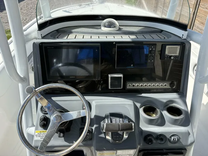  Yacht Photos Pics 2019 Tidewater 2700 Carolina Bay boat dashboard with steering wheel and electronic displays.