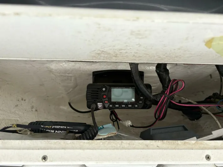  Yacht Photos Pics 2019 Tidewater 2700 Carolina Bay boat electronics compartment with radio and wiring.
