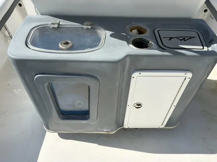  Yacht Photos Pics 2019 Tidewater 2700 Carolina Bay boat console with storage compartments and cup holders.