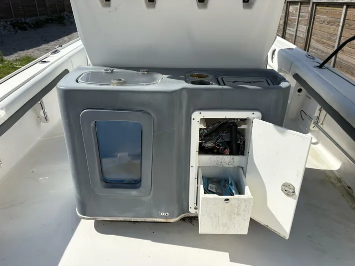  Yacht Photos Pics 2019 Tidewater 2700 Carolina Bay boat interior with open storage compartment and equipment.