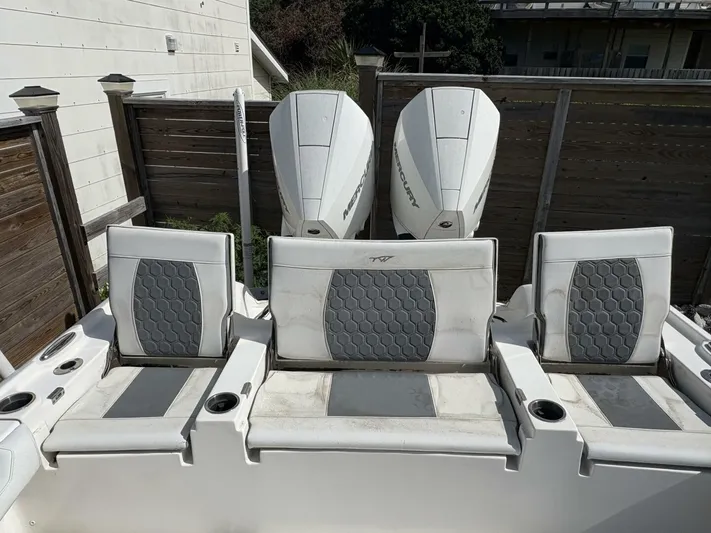  Yacht Photos Pics 2019 Tidewater 2700 Carolina Bay boat seats and Mercury engines in a backyard setting.