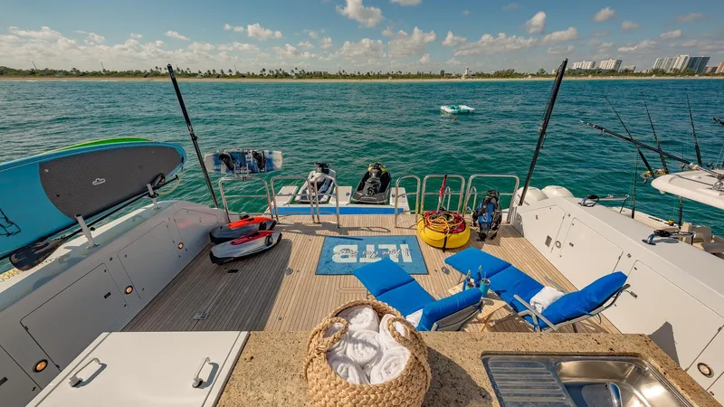 I Love This Boat Yacht Photos Pics Luxurious 2002 Christensen Tri Deck yacht deck with lounge chairs, water sports gear, and ocean view.