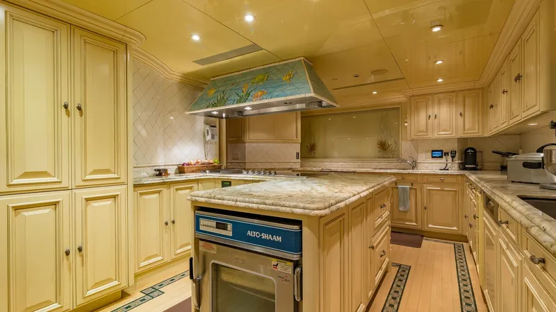 I Love This Boat Yacht Photos Pics Luxurious kitchen on 2002 Christensen Tri Deck yacht with elegant cabinetry and modern appliances.