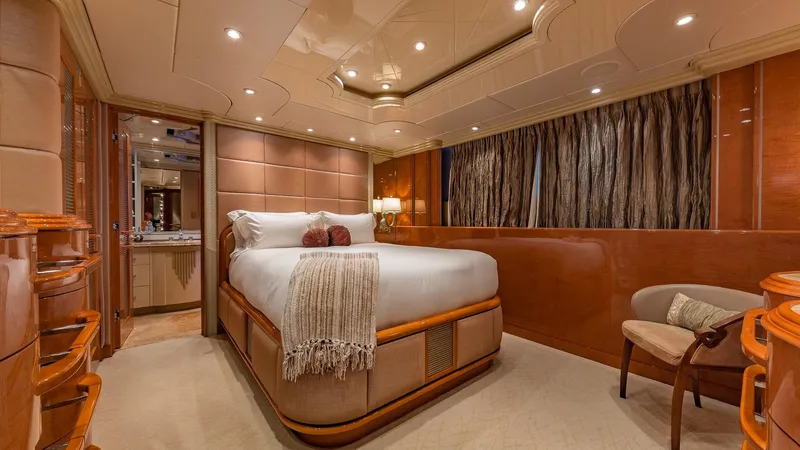 I Love This Boat Yacht Photos Pics Luxurious bedroom interior on 2002 Christensen Tri Deck yacht, featuring elegant wood paneling and plush bedding.