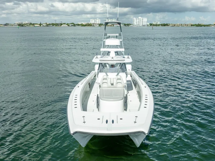 "whiskey Business" Yacht Photos Pics 2020 Freeman 42 LR boat on calm water, front view, under cloudy sky.