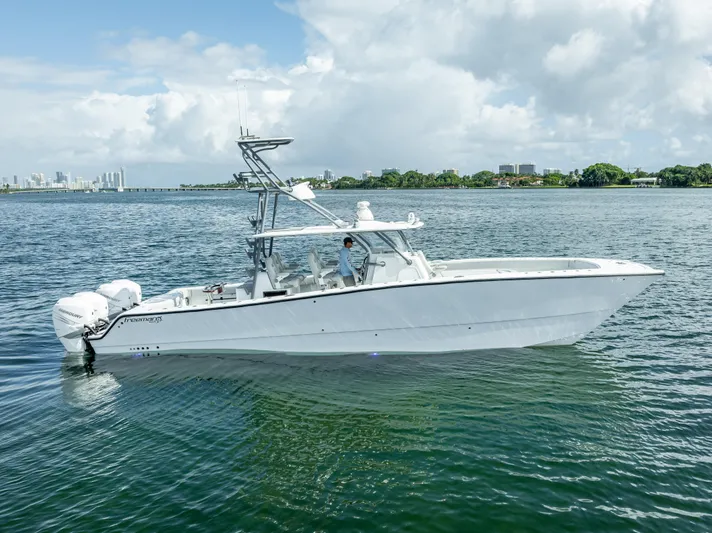 "whiskey Business" Yacht Photos Pics 2020 Freeman 42 LR boat on calm water with city skyline in background.