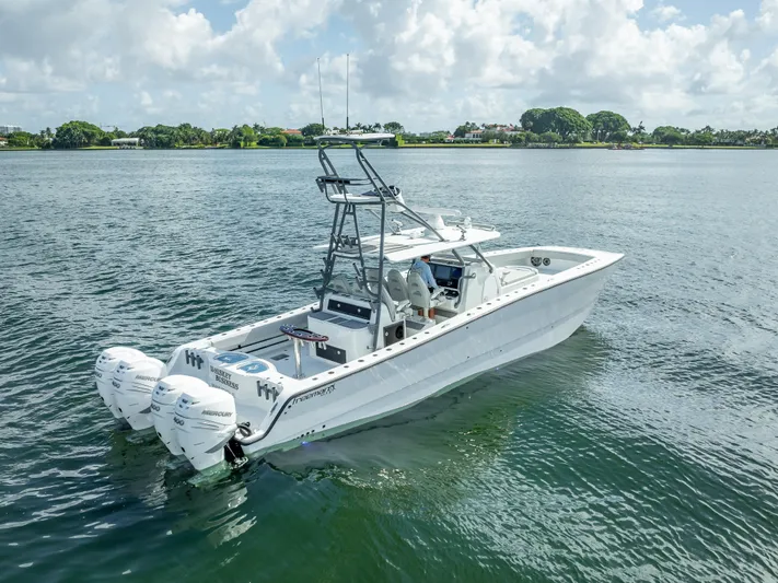 "whiskey Business" Yacht Photos Pics 2020 Freeman 42 LR boat on calm water with triple outboard engines.