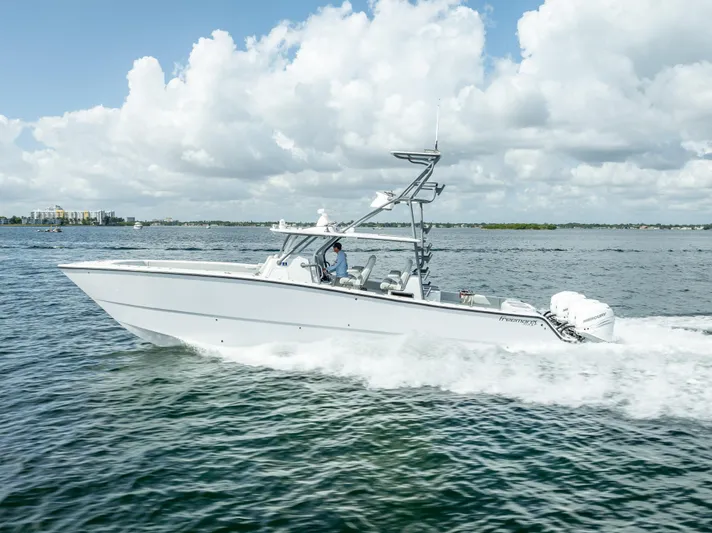 "whiskey Business" Yacht Photos Pics Freeman 42 LR 2020 boat cruising on open water under cloudy sky.