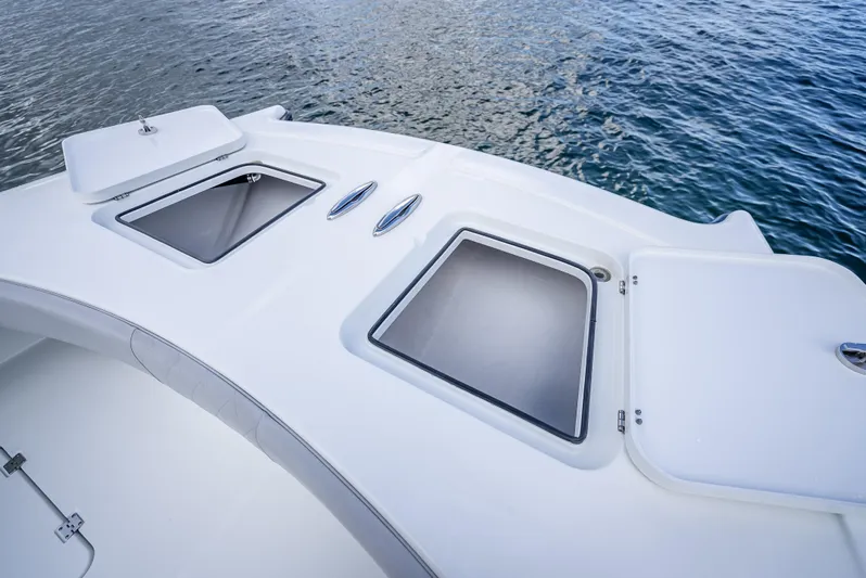 "whiskey Business" Yacht Photos Pics 2020 Freeman 42 LR boat deck with storage compartments on calm water.