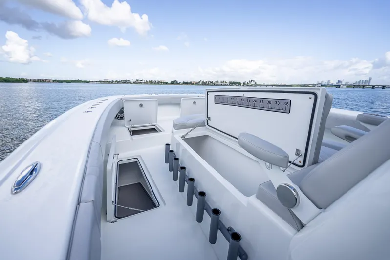 "whiskey Business" Yacht Photos Pics 2020 Freeman 42 LR boat interior with rod holders and storage, on calm water.