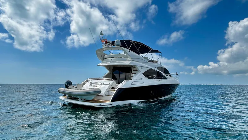 2006 Sunseeker Manhattan 60 @ Cancun Yacht Photos Pics 2006 Sunseeker Manhattan 60 yacht cruising on open water under a blue sky.