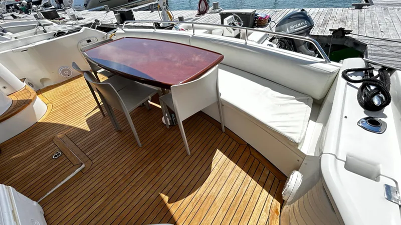 2006 Sunseeker Manhattan 60 @ Cancun Yacht Photos Pics Luxurious 2006 Sunseeker Manhattan 60 yacht deck with seating and table.