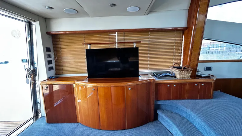 2006 Sunseeker Manhattan 60 @ Cancun Yacht Photos Pics Interior of 2006 Sunseeker Manhattan 60 yacht with wooden cabinetry and TV.