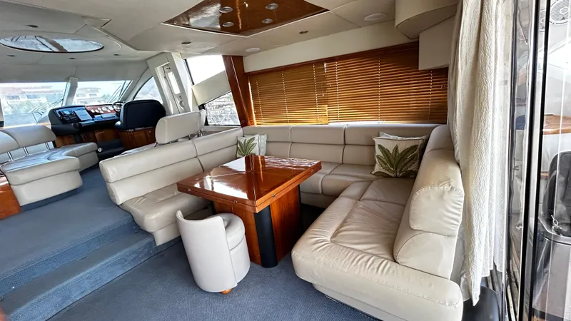 2006 Sunseeker Manhattan 60 @ Cancun Yacht Photos Pics Luxurious interior of 2006 Sunseeker Manhattan 60 yacht with plush seating and wooden accents.