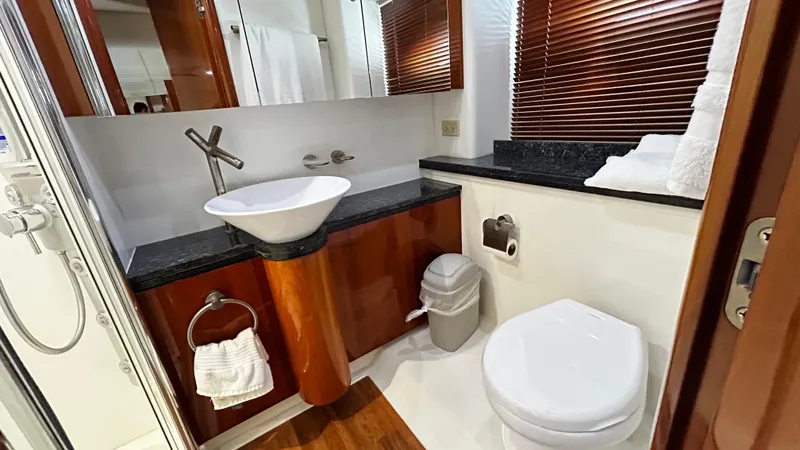 2006 Sunseeker Manhattan 60 @ Cancun Yacht Photos Pics Luxurious bathroom in 2006 Sunseeker Manhattan 60 yacht with modern fixtures and wooden accents.