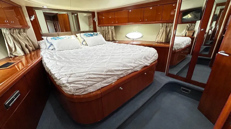 2006 Sunseeker Manhattan 60 @ Cancun Yacht Photos Pics Luxurious bedroom interior of 2006 Sunseeker Manhattan 60 yacht with elegant wood finishes.
