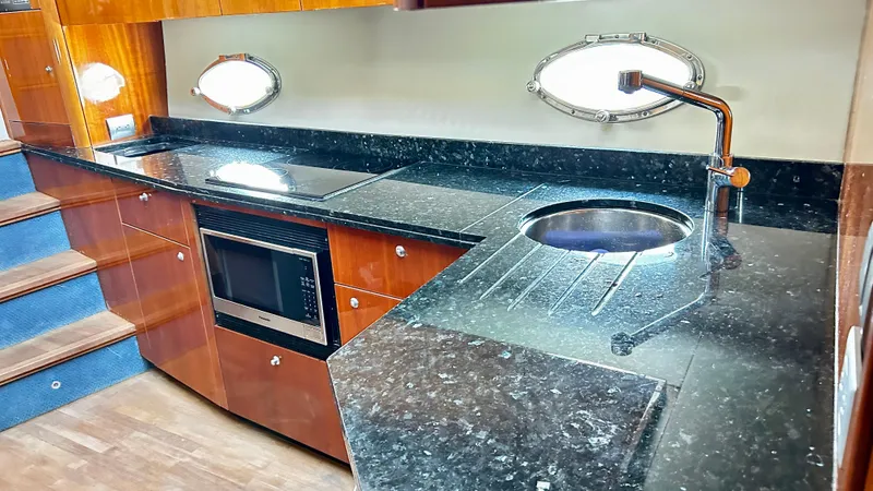 2006 Sunseeker Manhattan 60 @ Cancun Yacht Photos Pics Luxurious kitchen interior of 2006 Sunseeker Manhattan 60 yacht with modern appliances.