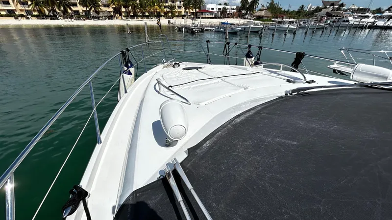 2006 Sunseeker Manhattan 60 @ Cancun Yacht Photos Pics Sunseeker Manhattan 60 yacht deck, 2006 model, docked in a marina with calm waters.