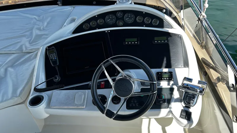 2006 Sunseeker Manhattan 60 @ Cancun Yacht Photos Pics Cockpit of 2006 Sunseeker Manhattan 60 yacht with steering wheel and control panel.