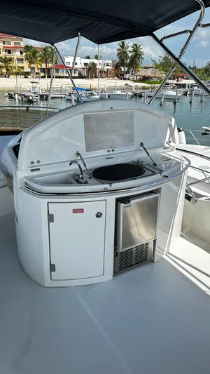 2006 Sunseeker Manhattan 60 @ Cancun Yacht Photos Pics Outdoor kitchen on 2006 Sunseeker Manhattan 60 yacht, featuring grill and mini fridge.