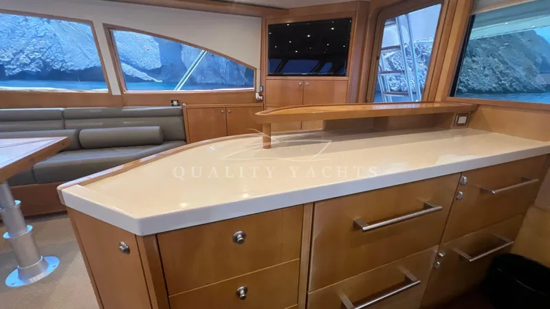 Saietta Yacht Photos Pics Interior of a 2010 Bertram Convertible yacht with modern cabinetry and ocean view windows.