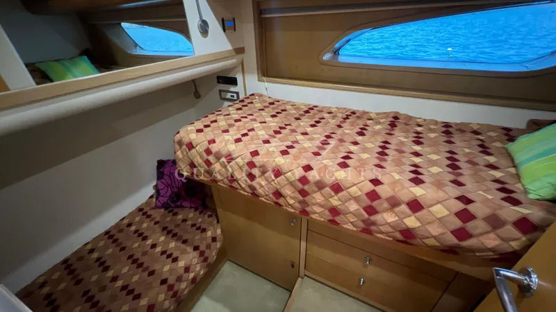 Saietta Yacht Photos Pics Bertram Convertible 2010 yacht interior cabin with twin beds and ocean view.