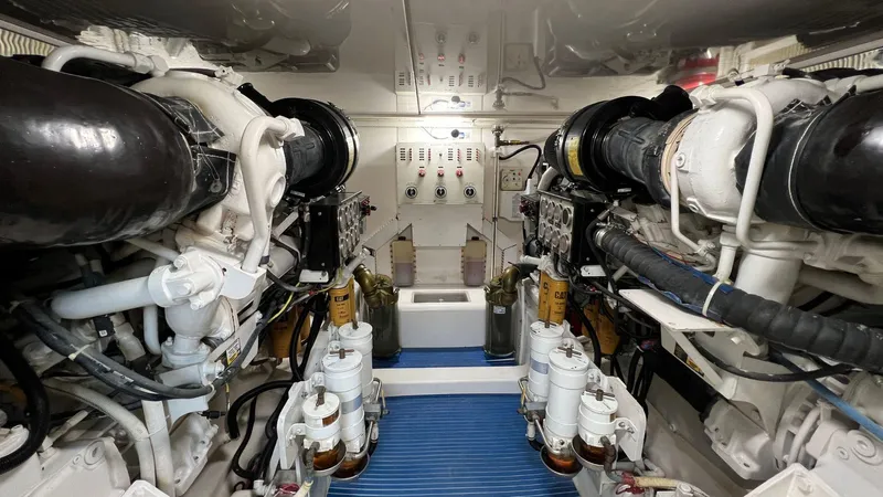 Saietta Yacht Photos Pics Engine room of a 2010 Bertram Convertible yacht with dual engines and control panel.