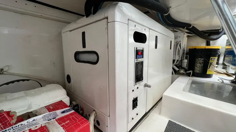 Saietta Yacht Photos Pics 2010 Bertram Convertible engine room with generator and battery.