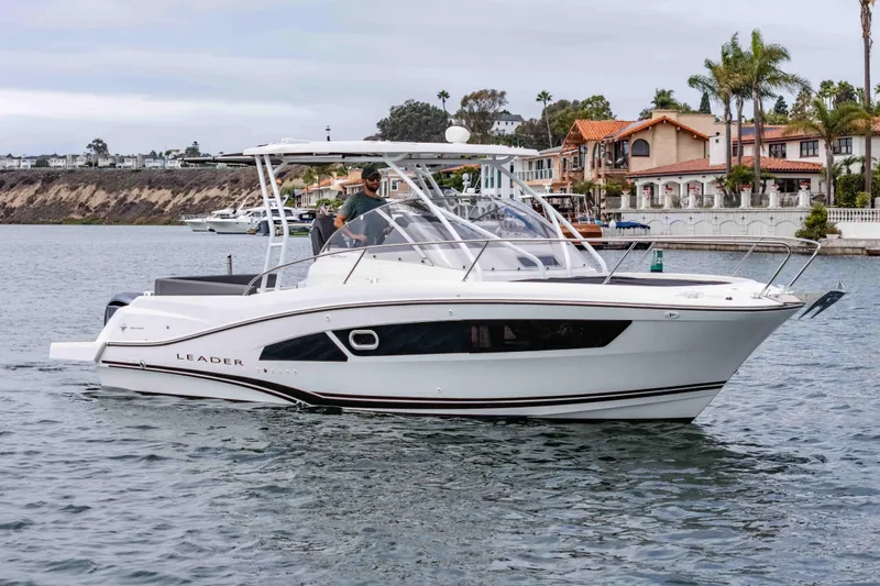  Yacht Photos Pics 2023 Jeanneau Leader 9.0 WA boat cruising near waterfront homes.