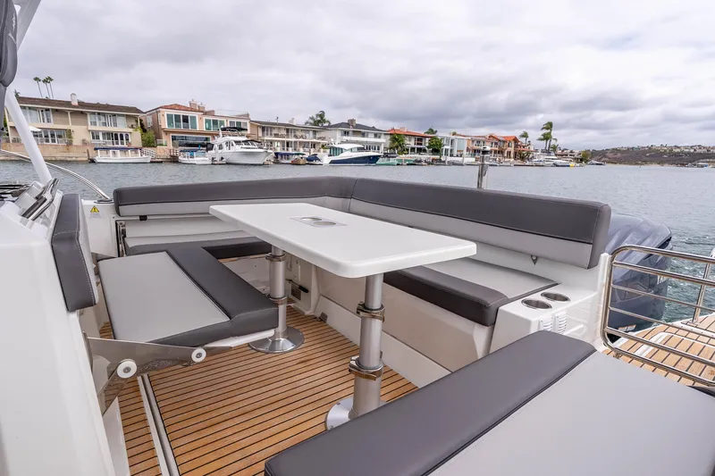  Yacht Photos Pics 2023 Jeanneau Leader 9.0 WA boat with spacious seating and table on deck.