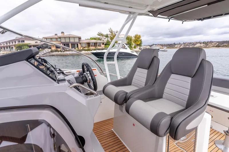  Yacht Photos Pics 2023 Jeanneau Leader 9.0 WA boat interior with dual seats and steering console.