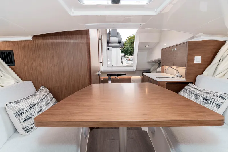  Yacht Photos Pics Interior of 2023 Jeanneau Leader 9.0 WA boat, featuring a cozy dining area and kitchenette.