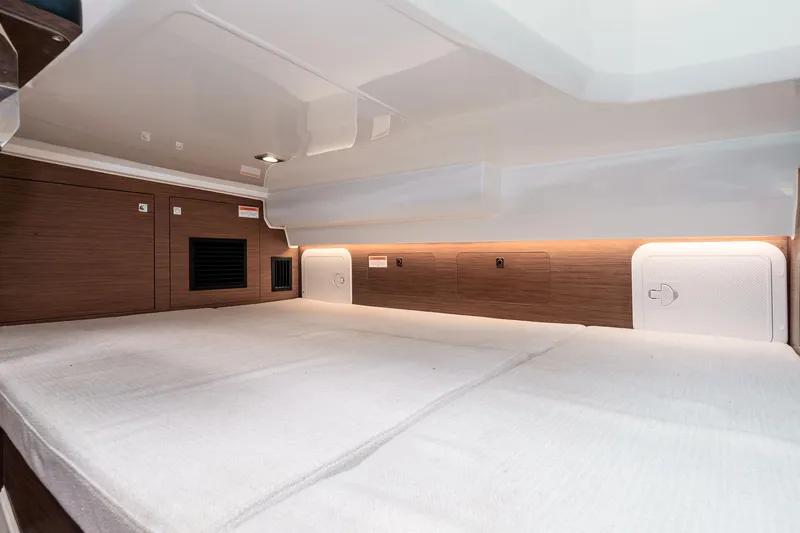  Yacht Photos Pics 2023 Jeanneau Leader 9.0 WA cabin interior with modern wood finish and ambient lighting.