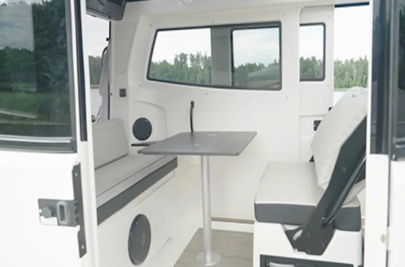 Yacht Photos Pics Interior of 2025 Navan C30 boat with seating and table, featuring modern design.