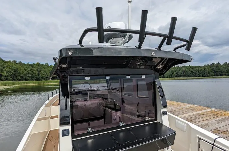  Yacht Photos Pics Navan C30 boat, 2025 model, docked by a serene lake with lush greenery.