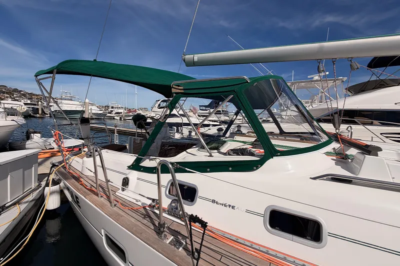 Tadpole Yacht Photos Pics 2005 Beneteau Oceanis Clipper 423 sailboat docked at marina, featuring green canopy.