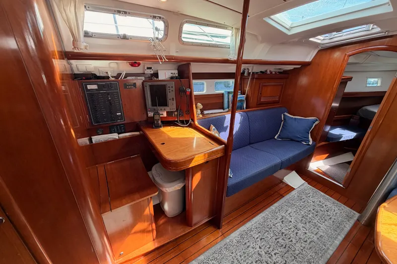 Tadpole Yacht Photos Pics Interior of 2005 Beneteau Oceanis Clipper 423 yacht with wooden finish and blue seating.
