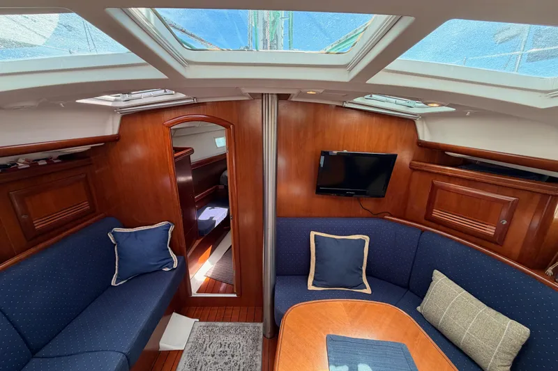 Tadpole Yacht Photos Pics Interior of 2005 Beneteau Oceanis Clipper 423 sailboat with cozy seating and wooden finishes.