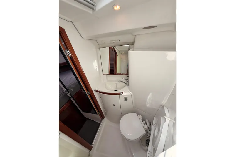 Tadpole Yacht Photos Pics Bathroom interior of 2005 Beneteau Oceanis Clipper 423 yacht, featuring sink and toilet.