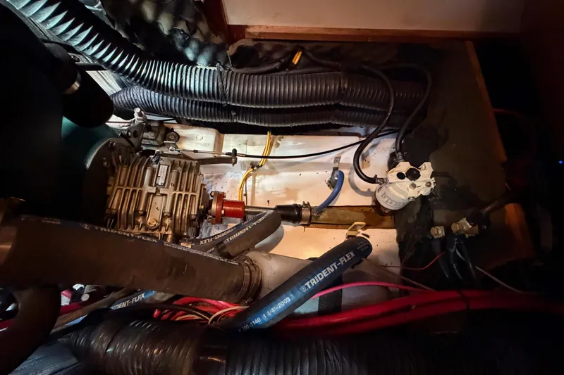 Tadpole Yacht Photos Pics Engine compartment of a 2005 Beneteau Oceanis Clipper 423 sailboat, showing mechanical components and hoses.