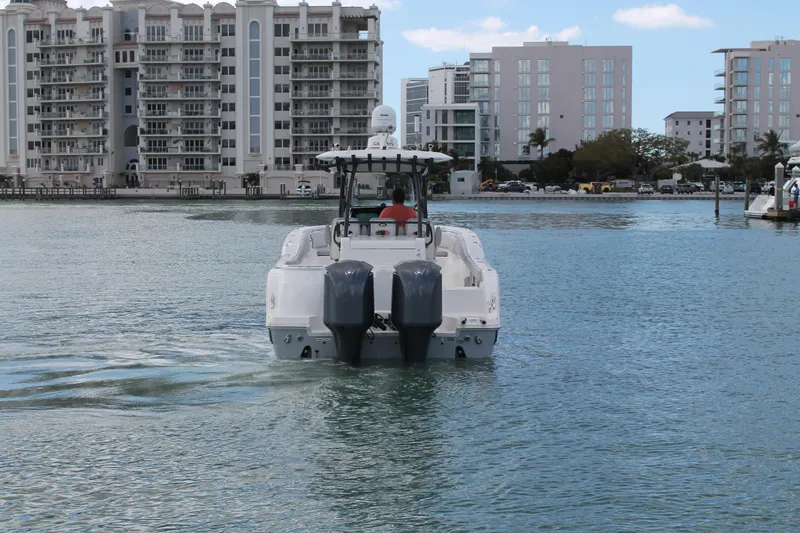  Yacht Photos Pics 2018 Sea Fox 328 Commander boat cruising near waterfront buildings.