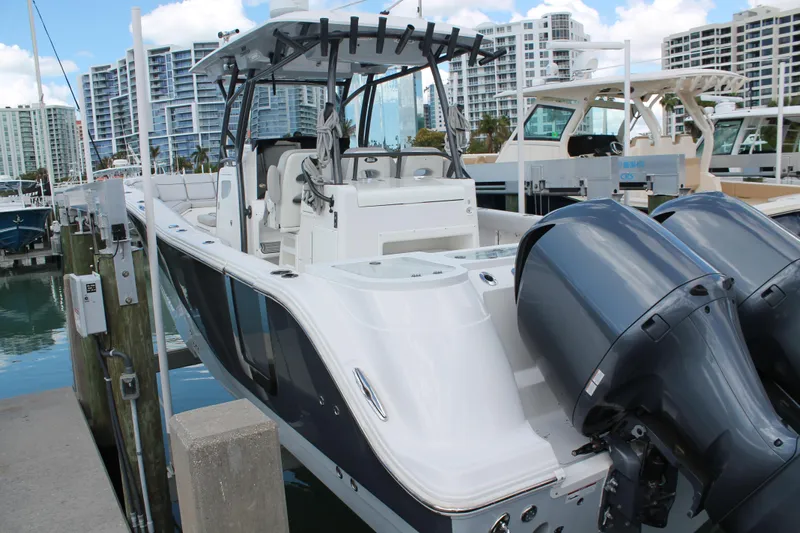  Yacht Photos Pics 2018 Sea Fox 328 Commander boat docked with twin engines, urban skyline background.