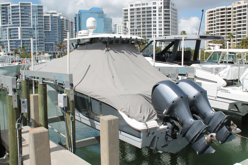  Yacht Photos Pics 2018 Sea Fox 328 Commander boat docked with cover, twin engines, and cityscape background.