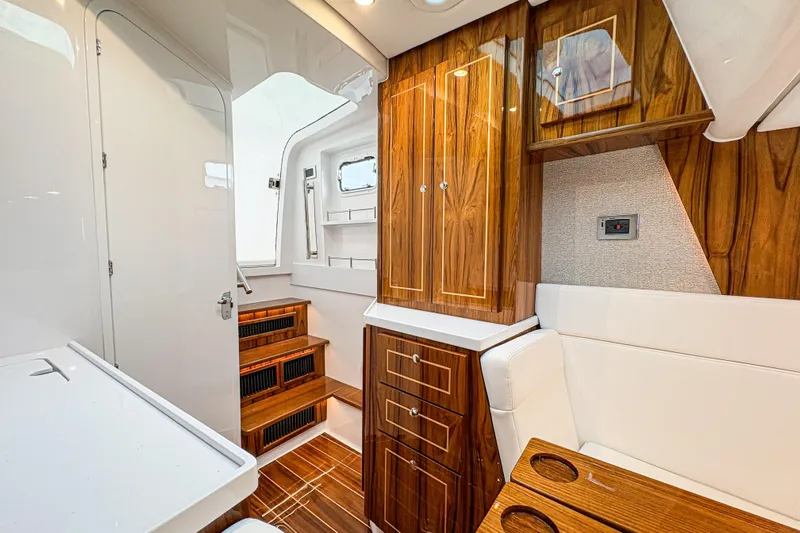  Yacht Photos Pics Luxurious interior of 2026 HCB 48 Campeon boat with elegant wood finishes.