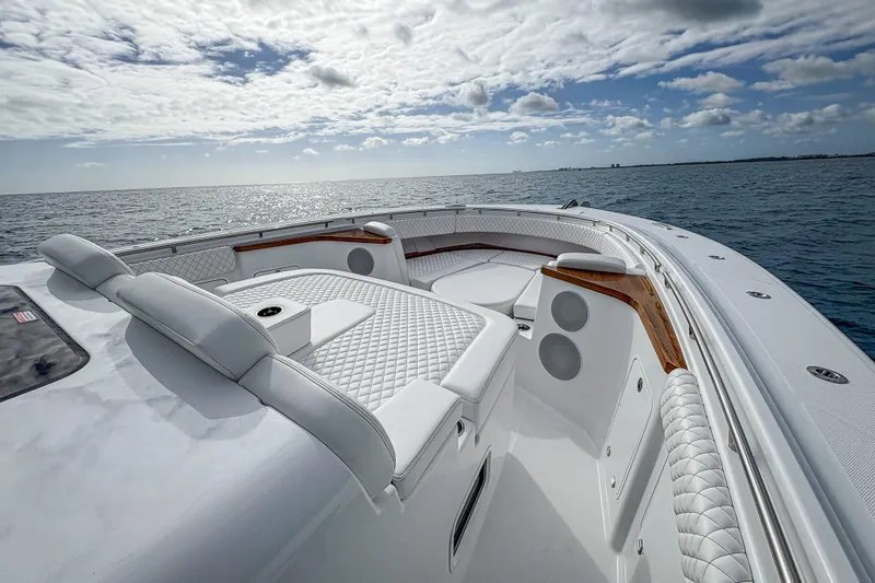  Yacht Photos Pics Luxurious 2026 HCB 48 Campeon yacht interior with plush seating, cruising on open sea.