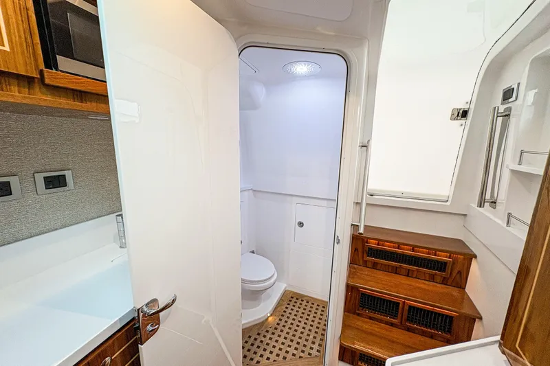 Yacht Photos Pics Luxurious bathroom interior of 2026 HCB 48 Campeon yacht with wooden accents.