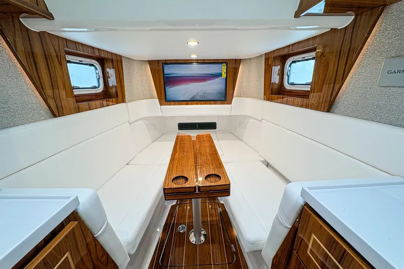  Yacht Photos Pics Luxurious interior of 2026 HCB 48 Campeon yacht with elegant wood and white seating.