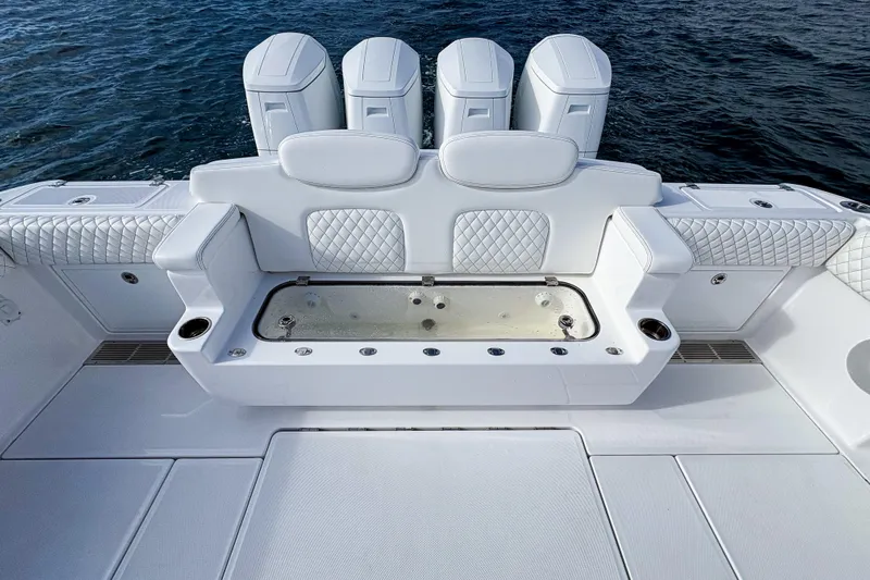  Yacht Photos Pics Luxury seating and storage on 2026 HCB 48 Campeon boat, featuring quilted white upholstery.